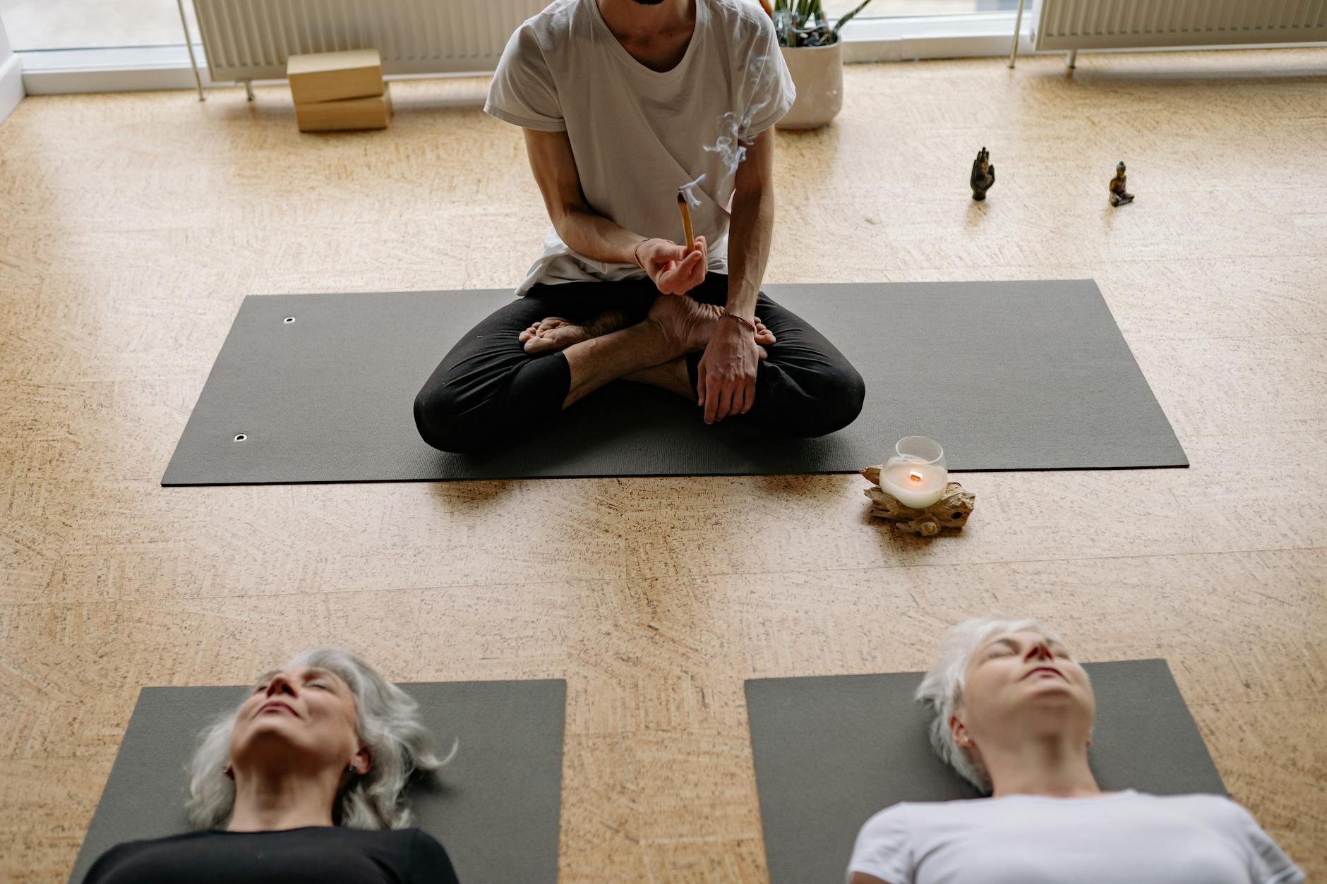 Man holding a strong yoga pose on a mat.